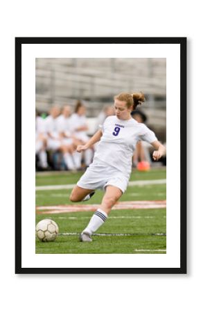 Female soccer player shooting on goal