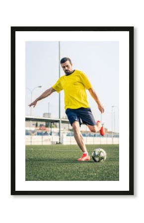 young man playing soccer on a grass field