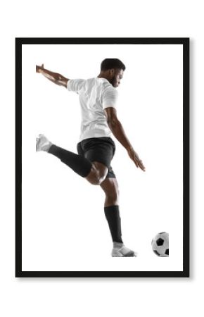 Young African man, male football soccer player in motion, training, hitting ball isolated on transparent background. Concept of sport, competition, tournament, hobby, active lifestyle