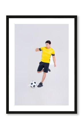 Portrait of Asian man playing soccer on white background