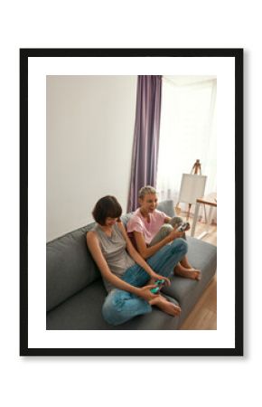 Young smiling lesbian girls playing video game