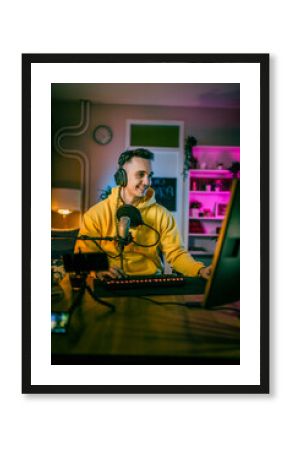 Young man male gamer playing computer game streaming video online