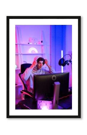 Caucasian esport player boy wearing grey hoodie ready to competition with his friend battle game online leisure lifestyle in entertainment studio at home