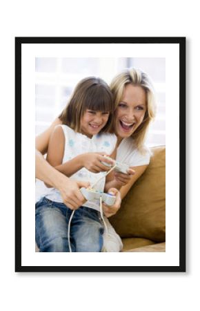 Woman and young girl in living room with video game controllers