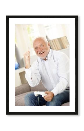 Senior man winning on computer game