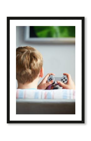 Rear View Of Boy Holding Controller Playing Video Game