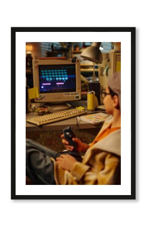 Person absorbed in playing classic video game on old school computer setup in cozy, cluttered room with nostalgic vibes