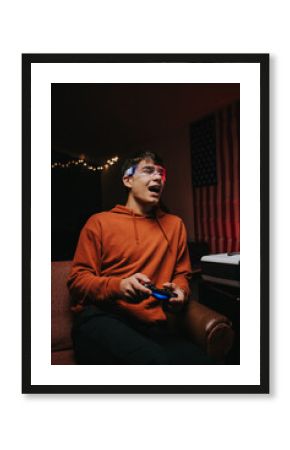 Young man in glowing glasses playing video game