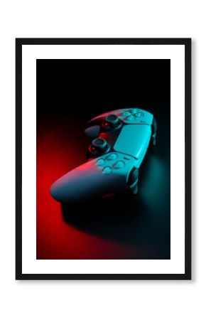 Modern white gamepad illuminated in red and blue. Game controller for video games and e-sports on a dark back