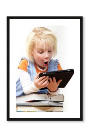 Little blond girl is reading on touchpad