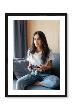 KYIV, UKRAINE - APRIL 9, 2020: attractive woman playing video game with joystick on self isolation