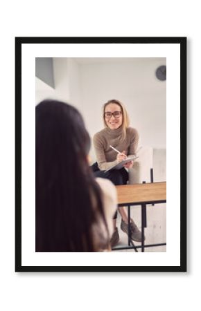 Smiling female psychologist listening to client during session