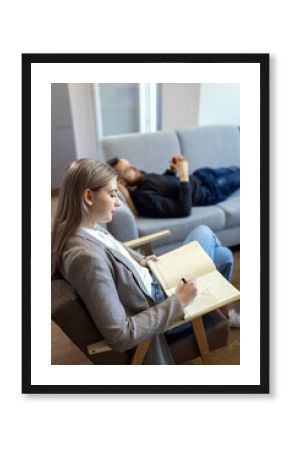 Young man talking to female psychologist during session.