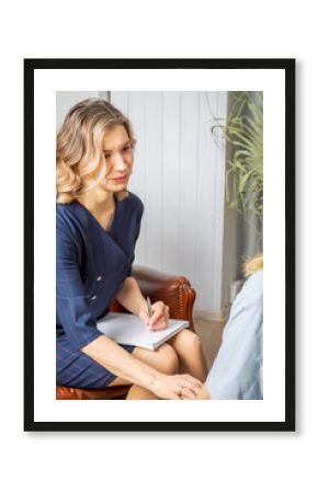 A female psychologist calms the girl, touching her hands