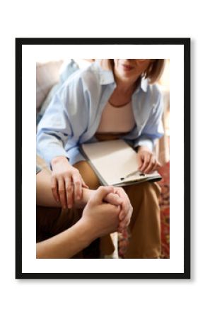 Close-up of mature psychologist supporting man during consultation in office