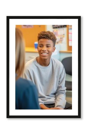 Psychologist communicating with a teenage boy in school office