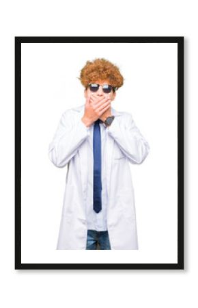 Young handsome scientist man wearing professional coat and sunglasses shocked covering mouth with hands for mistake. Secret concept.