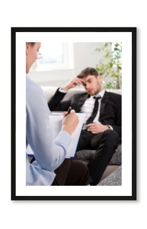 Oppressed man talking with psychologist