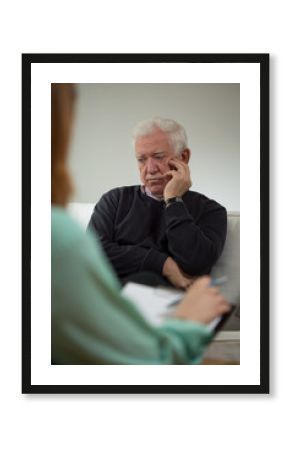 Sad man talking with psychiatrist