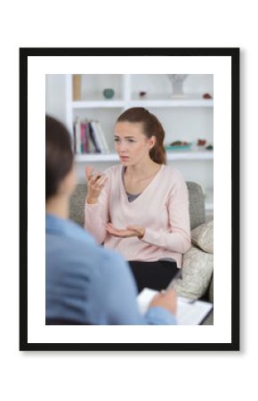 Woman making hand gestures while talking to therapist