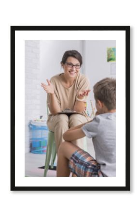 Smiling woman talking to boy
