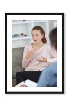 worried young woman talking about her problems with psychologist