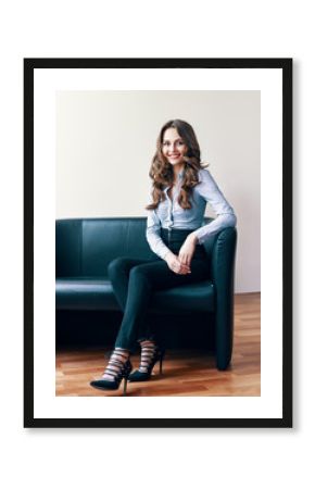 Portrait of beautiful female psychologist sitting on a couch