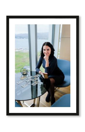 Woman is reading Tarot cards on the table. Divination, occult, esoteric concept.