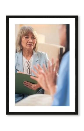Asian Concerned woman talks with mental health professional Advice, discussion or woman in therapy, counselling or consultation for mental health mental health counselling from a female therapist