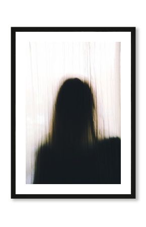 Anonymous silhouette unrecognizable with a long hair person behind a curtain