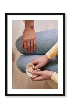 Top view close up of unrecognizable young woman holding tissue and crying during therapy session in support group