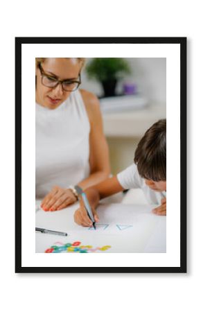 Child drawing shapes in a preschooler assessment test.