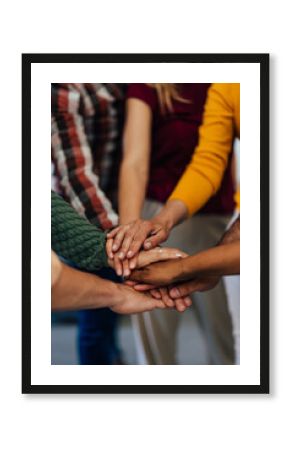 People standing in a circle and holding hands together, in the middle.