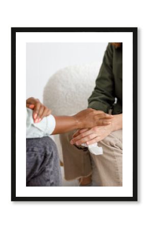 mental support to hold hands, handshake. An African-American female psychologist holds an appointment with a patient in the office. mental health and moral support. a female patient with mental