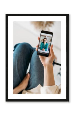 Video call. Online counseling. Mobile conference. Relaxed woman watching cheerful smart female expert on phone screen at home interior.