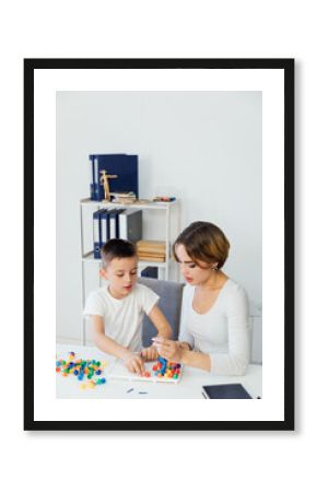 a child psychologist is engaged with a child in the office