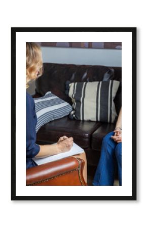 oman psychologist talking to a client. Hands with notepad. Close-up