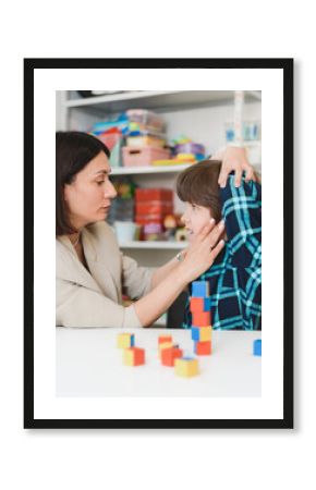 Cute preschool child is engaged in speech therapist office and correcting his speech