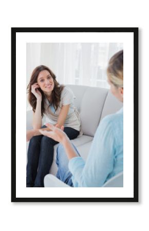 Happy woman sitting with her therapist talking to her