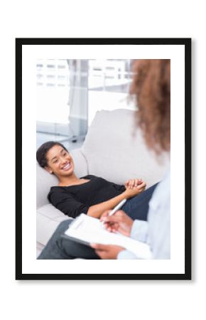 Woman laughing on sofa during therapy session