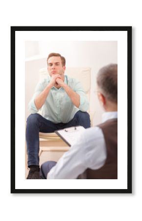 Stressful businessman is consulting a psychologist