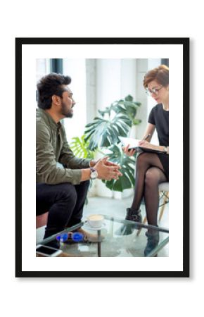 psychotherapist consulting man, asking questions, interviewing man sitting on sofa. psychologist with client