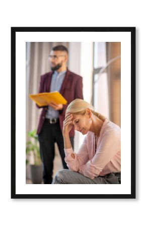 Blonde-haired woman sharing her stress with psychologist