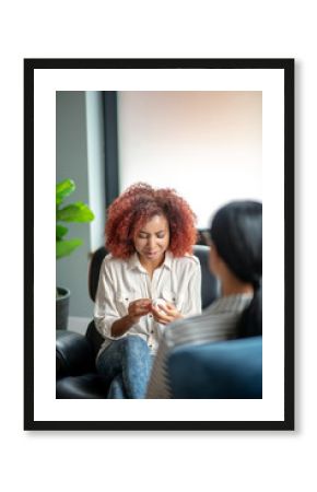 Curly young woman discussing antidepressants with psychologist