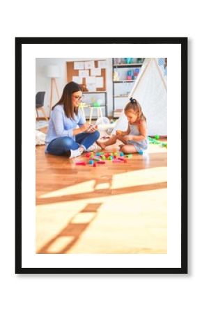 Young therapist woman speaking and treating child, counselor and behaviour correction at pedagogue payroom taking notes on clipboard