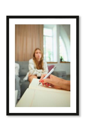 Family therapy session with psychologist taking notes in bright office. Concept of psychology, support for parents, communication in crisis and adolescent counseling.