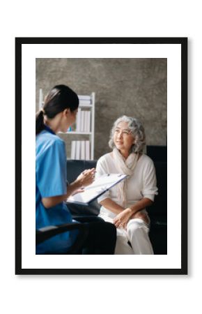 Asian caregiver doctor examine older patient woman therapist nurse at nursing home taking care of senior elderly woman sit on sofa