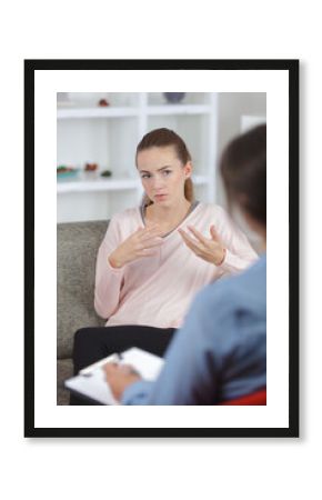 female psychologist making notes during psychological therapy