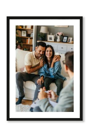 Young couple hugging on sofa during therapy session with psychologist