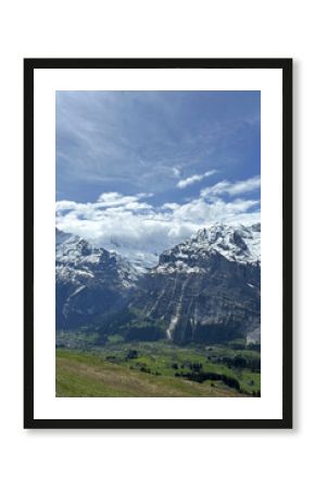 Swiss of towering mountains valleys under bright sky creates serene picturesque Switzerland landscape hiking destination.